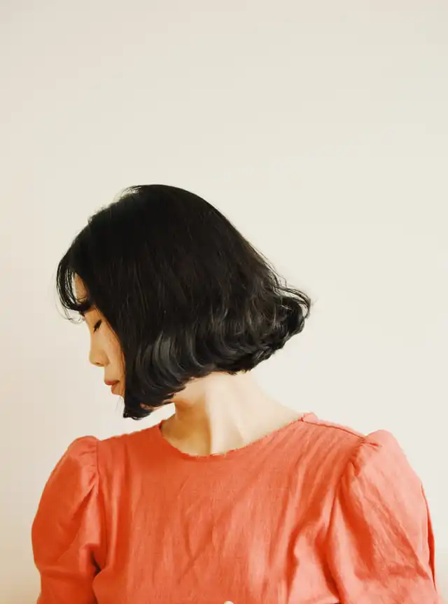 A woman with brunette bob haircut